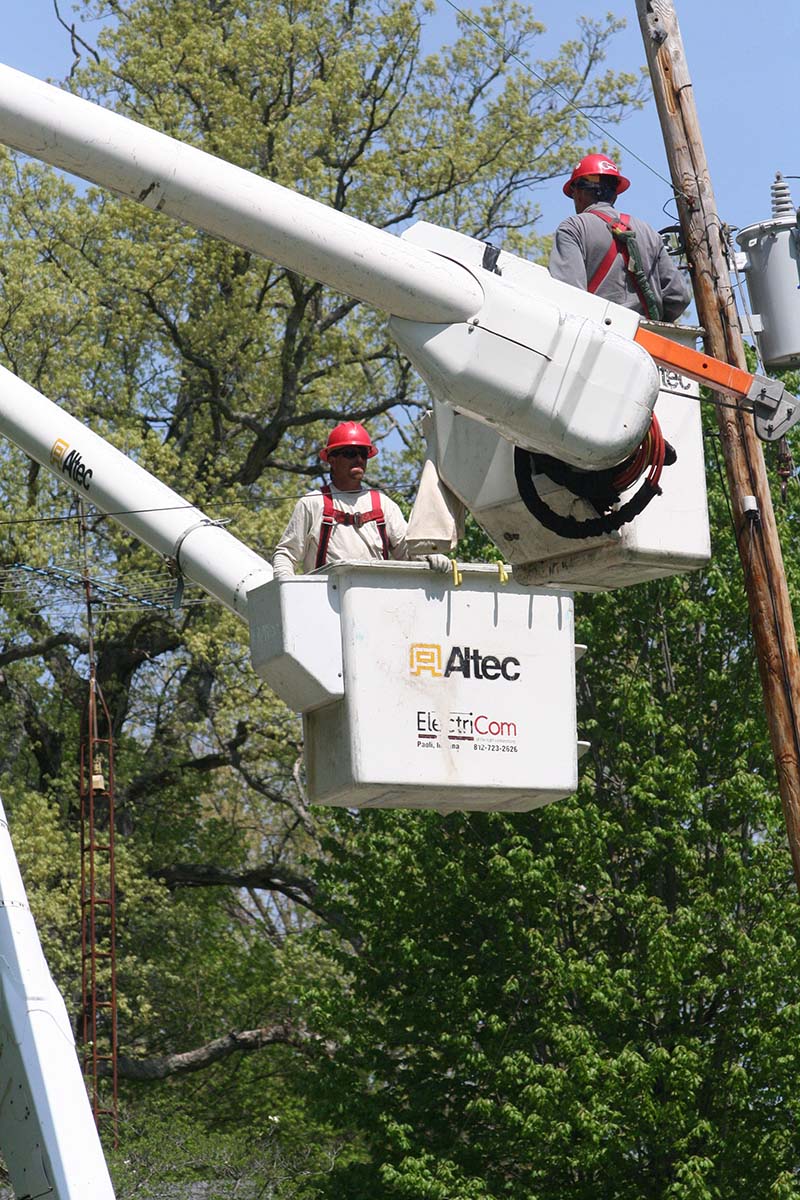 workers in cherry picker crane outdoors